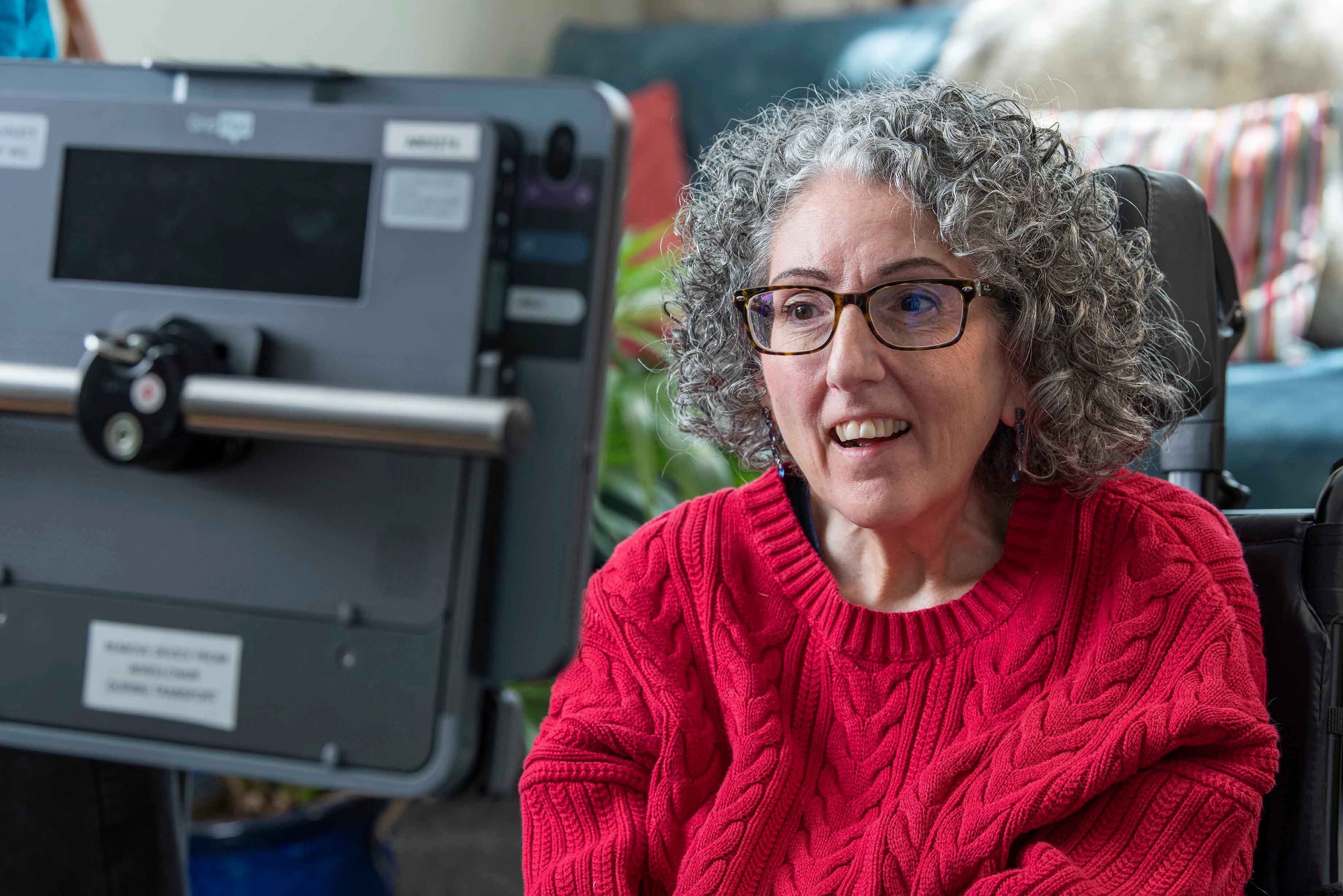 Sarah Ezekiel, a woman using eye gaze technology to operate a tablet displaying Smartbox Grid communication software