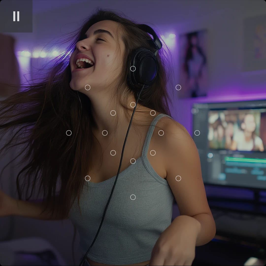 A young woman with long hair wearing headphones, smiling and enjoying music or a video in a room with purple lighting.