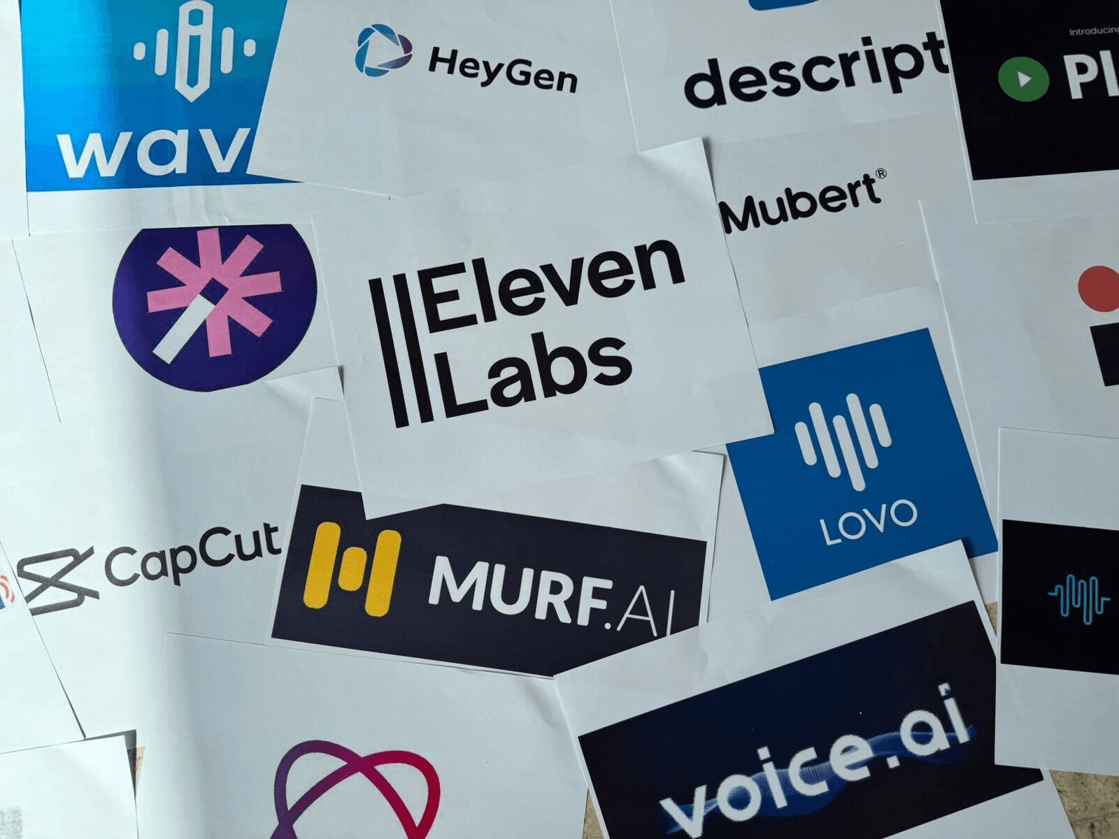 Collection of various company and product logos on paper stickers.