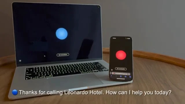 A laptop and smartphone on a wooden table, both displaying a red and blue recording indicator, with a message about a call from Leonardo Hotel.