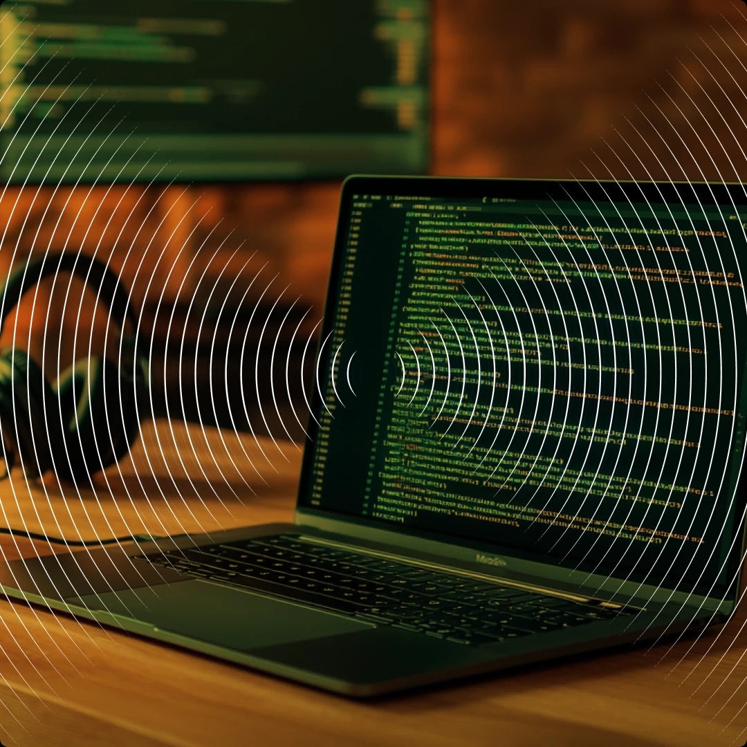 A laptop displaying lines of code with concentric circle patterns overlaid on the image.