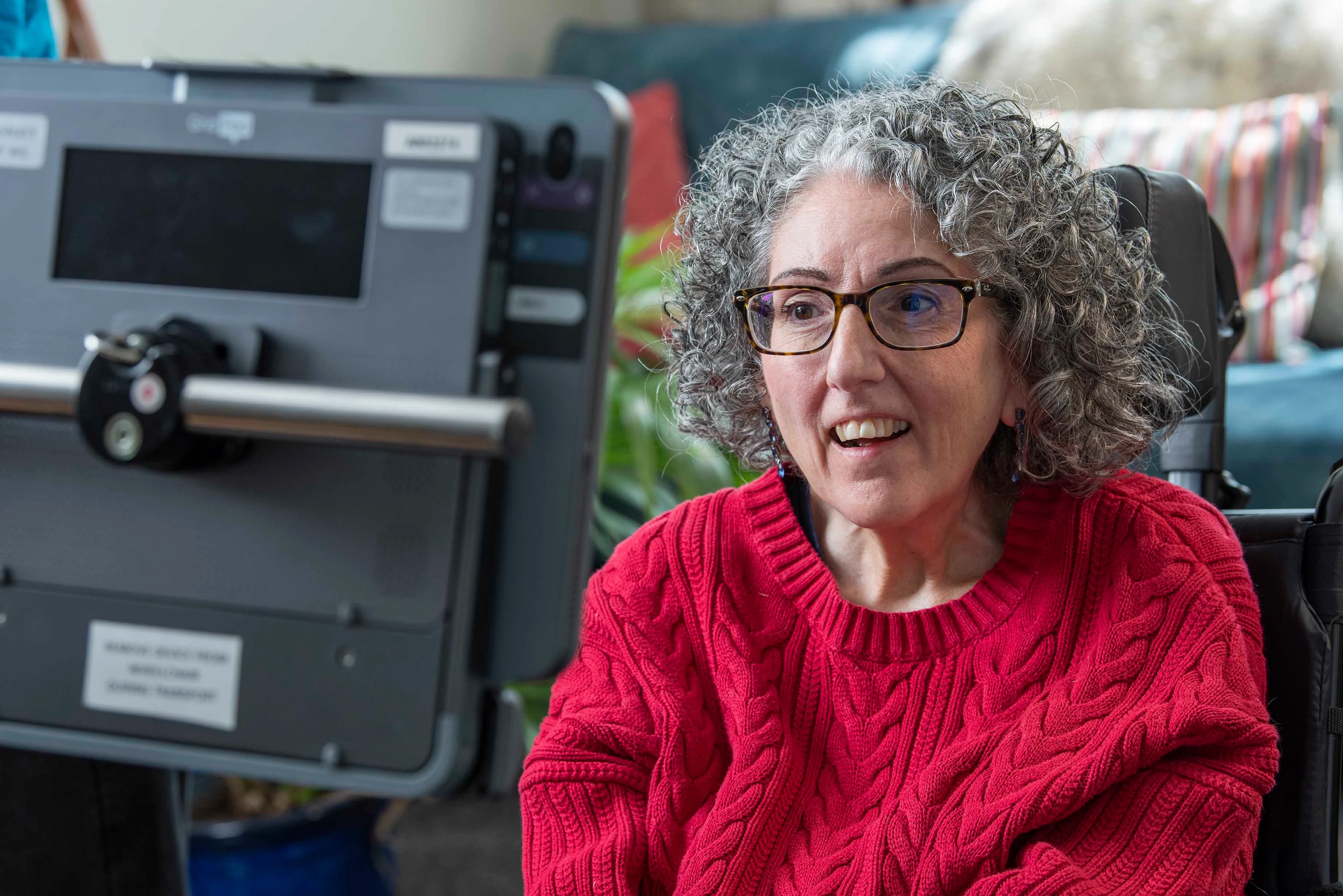 Sarah Ezekiel, a woman using eye gaze technology to operate a tablet displaying Smartbox Grid communication software