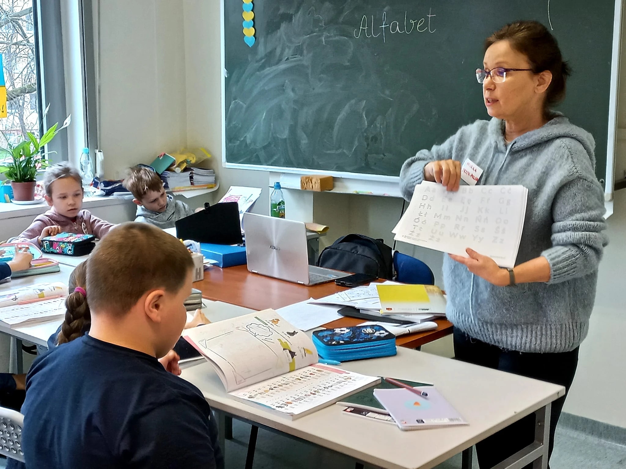 Teacher stands in front of her room giving a lecture