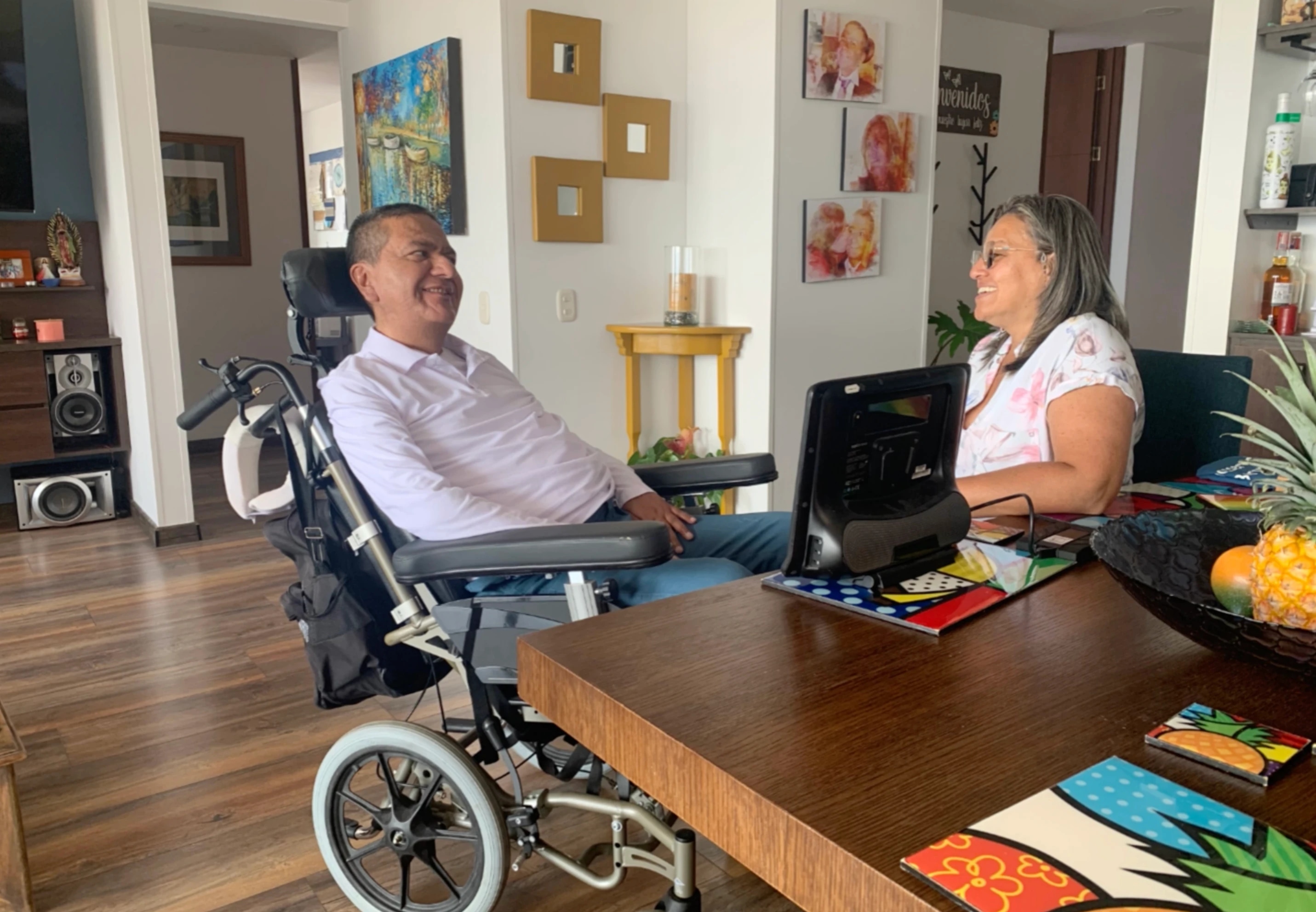 Orlando Ruiz sitting by the table with his wife